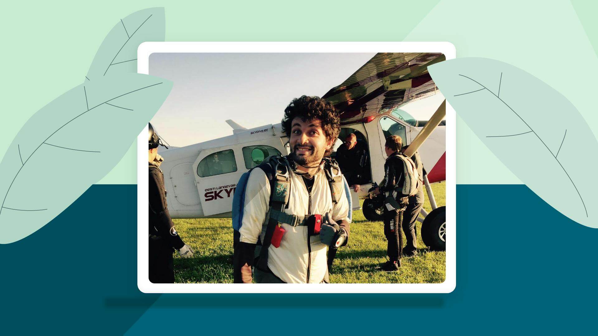 A man smiling with his thumbs up standing outside a plane.