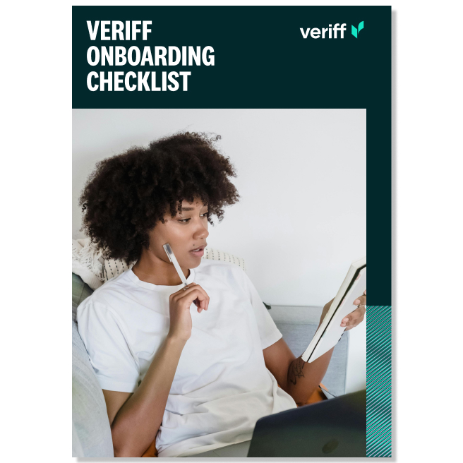 a woman holding a pen and looking at a book