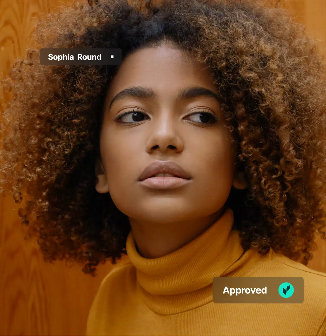 Person with curly hair, wearing turtleneck.